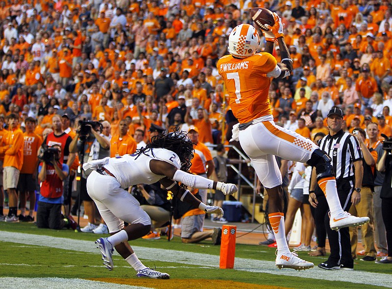 Tennessee wide receiver Preston Williams (7) catches a touchdown pass as he's defended by Western Carolina defensive back Jaleel Lorquet (2) during the first half of an NCAA college football game Saturday, Sept. 19, 2015 in Knoxville, Tenn. 