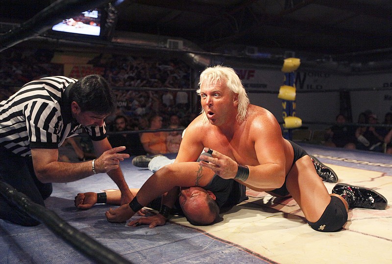 Paul E. Lee, "The Real Nature Boy," attempts to pin Shannon Mann, "Iron Man," while wrestling during the American Torture Match at FW Arena in Ringgold, Ga., on Saturday, August 20, 2011.