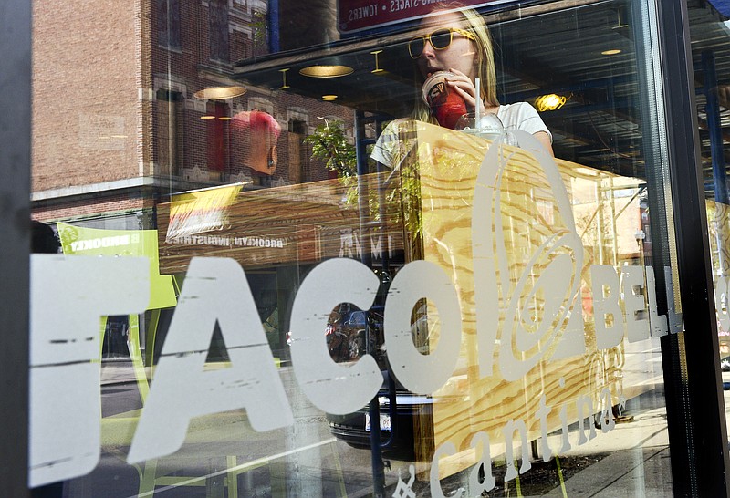 
              A customer at the new Taco Bell Cantina restaurant tries out Twisted Freeze, mixed drink, Tuesday, Sept. 22, 2015, in Chicago. The chain, which is owned by Yum Brands Inc., opened the location that serves wine, beer, sangria and frozen mixed drinks in Chicago. (AP Photo/Matt Marton)
            