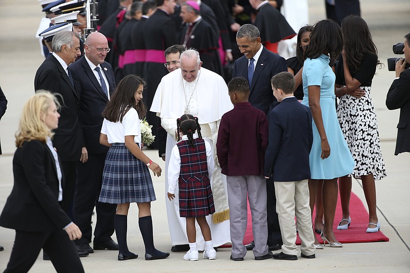 Children greet Pope Francis upon his arrival for a first-ever visit to the United States, at Joint Base Andrews on Tuesday.