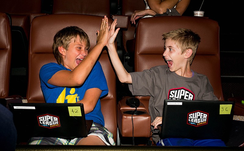 
              This Wednesday, Sept. 16, 2015 photo provided by Super League Gaming shows gamers attending the first in-theater video game league for multi-players of all ages to compete in the Super League Gaming event held at Cinemark Playa Vista and XD Theater in Los Angeles. (Super League Gaming via AP)
            