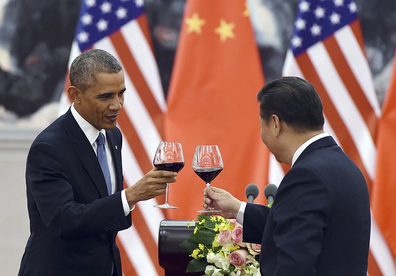 
              FILE - In this Nov. 12, 2014, file photo, President Barack Obama toasts with Chinese President Xi Jinping at a lunch banquet in the Great Hall of the People in Beijing. There could be some awkward undercurrents when the Chinese president is honored with a state dinner at the White House on Friday. The Obama's will honor a guest whose country has been accused of cyberspying, trampling on human rights and engaging in assertive military tactics.  (AP Photo/Greg Baker, File-Pool)
            