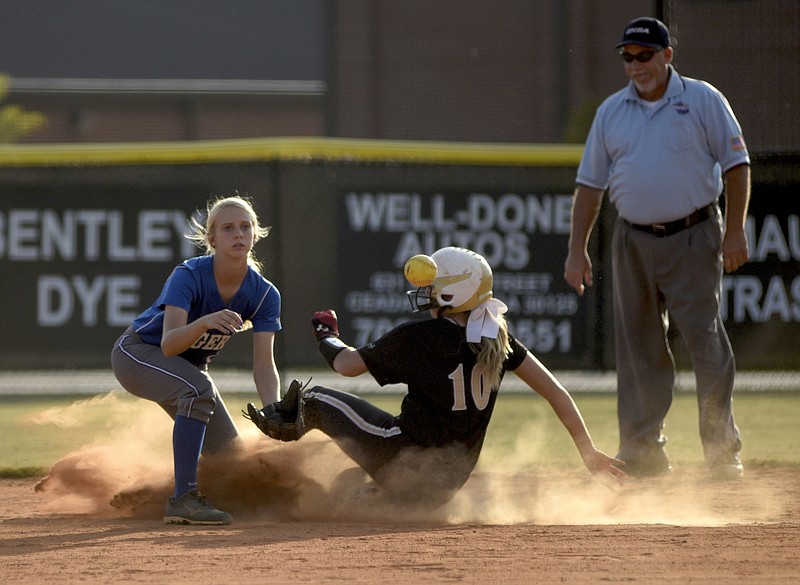 Calhoun's Jana John raises a cloud of dust as she slides safely ahead of the throw to Ringgold shortstop Kayla Woody as Calhoun hosts Ringgold in a girls softball game on Tuesday, Sept. 22, 2015, in Calhoun, Ga. Ringgold defeated Calhoun 6-5.