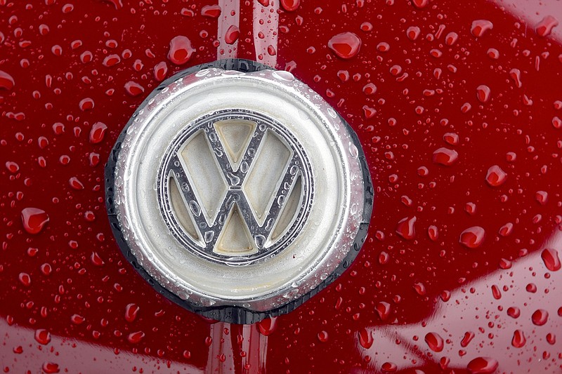Water beads up on the VW insignia on the hood of a car in this April file photo.