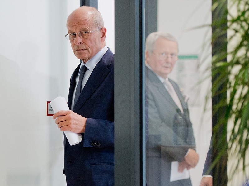 
              Berthold Huber, acting head of Volkswagen's supervisory board, left, and supervisory board member Wolfgang Porsche, right,  arrive for a statement announcing that CEO Martin Winterkorn stepped down amid an emissions scandal in the company's headquarters in Wolfsburg, Germany, Wednesday, Sept. 23, 2015. (Julian Stratenschulte/dpa via AP)
            