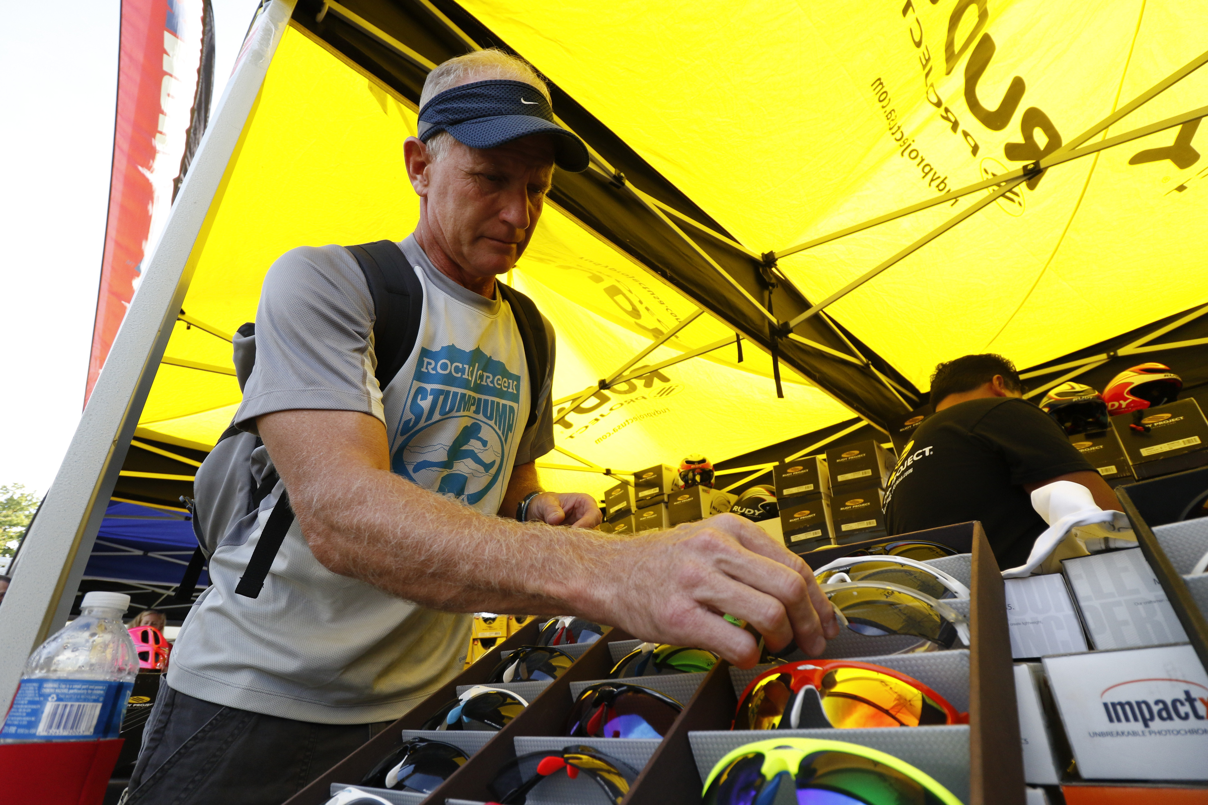 Local athlete Brian Crooks looks at Rudy Project sunglasses while visiting the Ironman Village in preparation for the second annual Ironman Chattanooga triathlon which will take place Sunday, September 27, 2015.