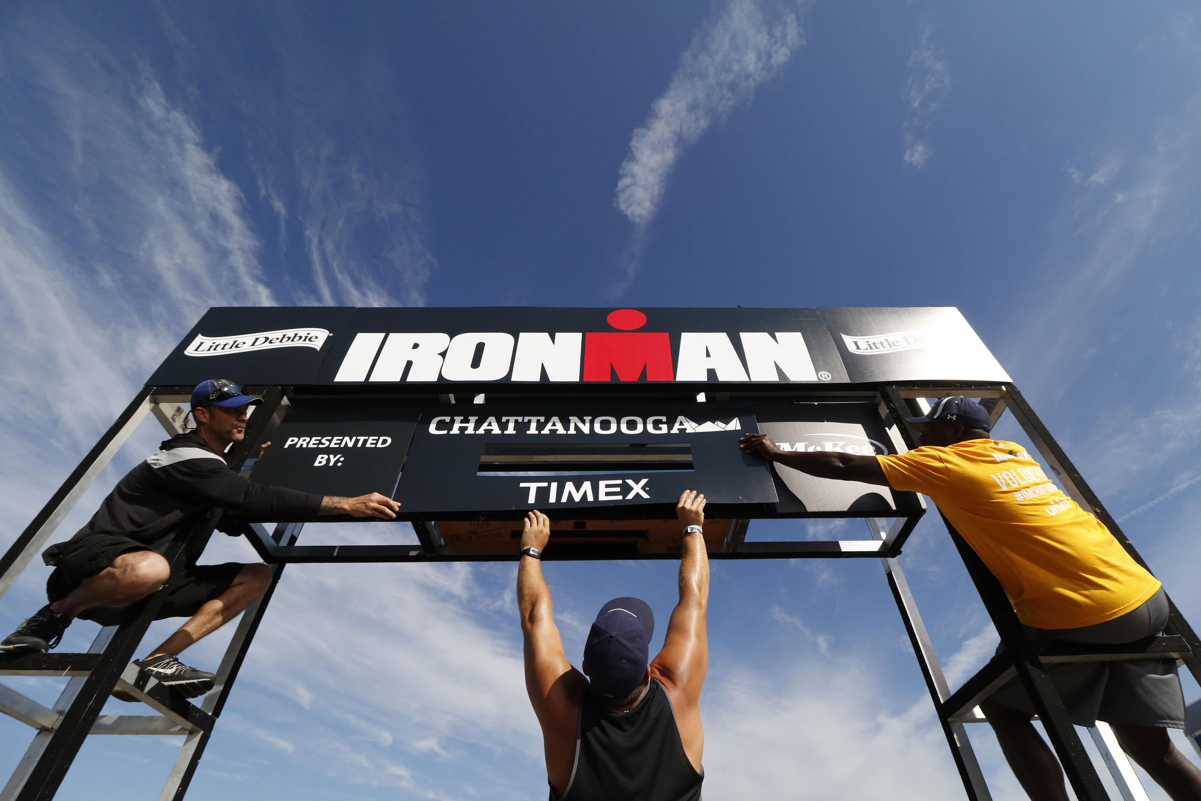 Jocks Murray, Sam Scaletta and Robert Thomas, from left, assemble the finish line structure in preparation for the second annual Ironman Chattanooga triathlon which will take place Sunday, September 27, 2015.