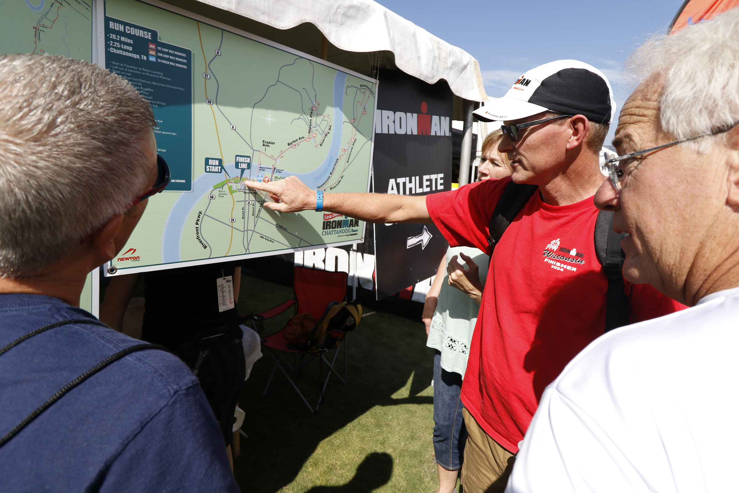 Sixth time Ironman competitor Steve Johnson, center, helps other competitors understand Sunday's run route in preparation for the second annual Ironman Chattanooga triathlon which will take place on September 27, 2015.