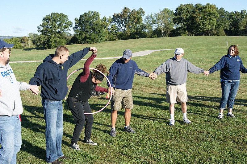 Employees with Regis work with the Adventure Guild in team-buildng exercises that the general manager of the company's Chattanooga distribution center says are beneficial to the company's culture.