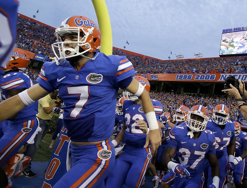 Florida players, including quarterback Will Grier (7) take the field during the first half of an NCAA college football game against New Mexico State, Saturday, Sept. 5, 2015, in Gainesville, Fla. (AP Photo/John Raoux)