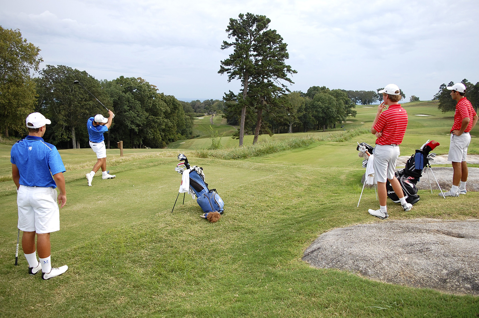 (From left) McCallie's Christopher Burkhart watches as teammate Evan Spense tees off, while Baylor's Chase Roswall and Oliver Simonsen look on.  Baylor faced McCallie in match play golf at the Lookout Mountain Golf Club on Thursday, September 24, 2015.