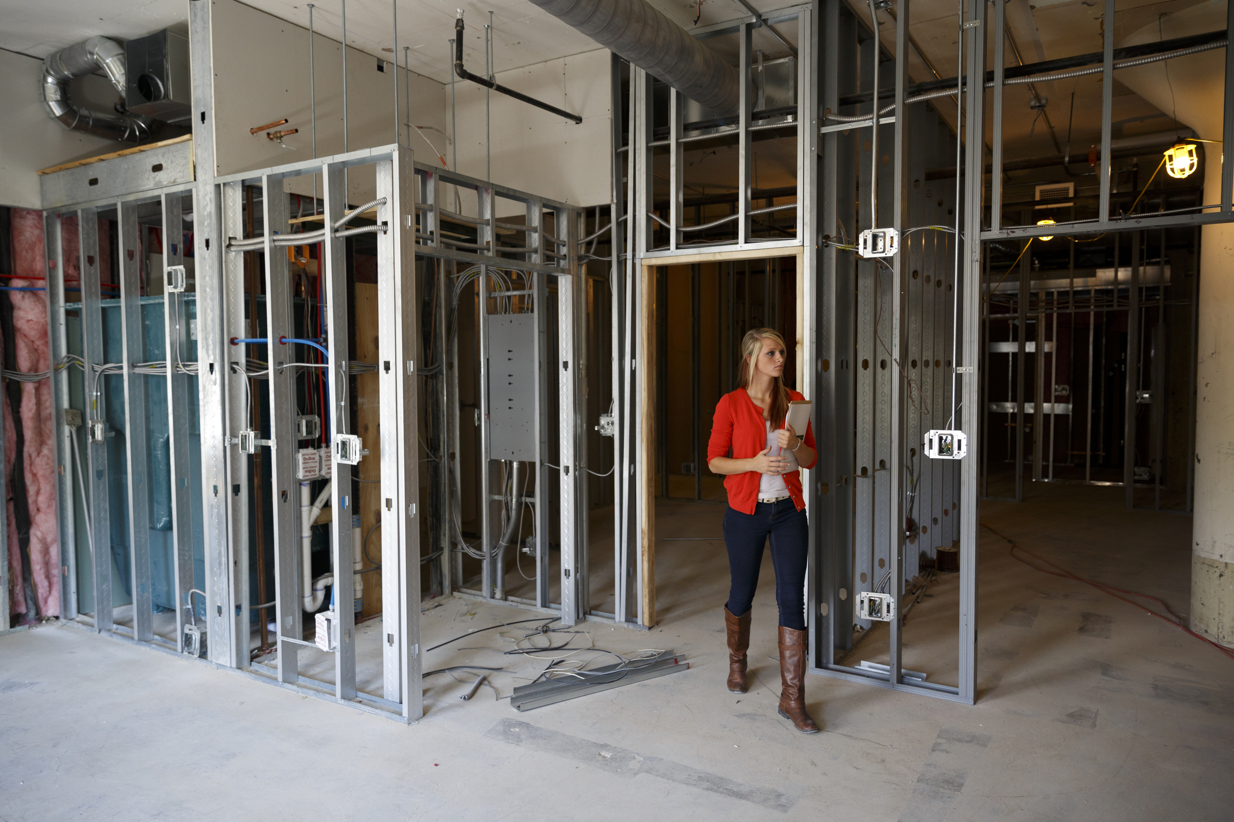 Gabby Palmer walks through a floor of loft apartments under development at the Clemons building Wednesday, Sept. 23, 2015, in Chattanooga, Tenn. The building, which dates back to the early 1920s, is being restored to offer luxury downtown loft apartments by owner and developer Vic Desai.