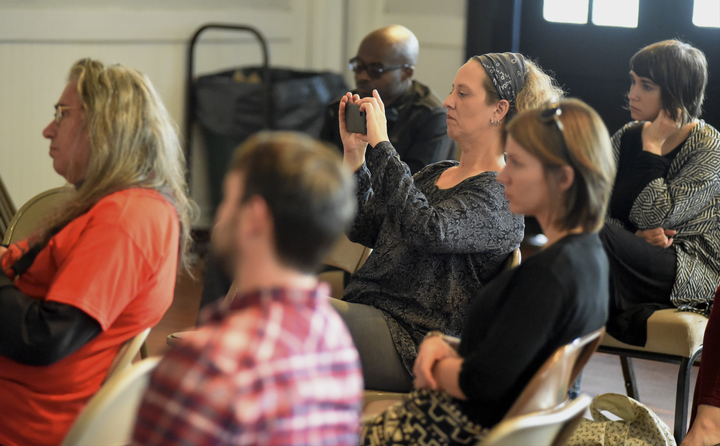 Beth Foster takes a photo with her phone during a worship service at the Mercy Junction Justice and Peace Center at St. Andrews in the Highland Park community on Sunday, Sept. 13, 2015, in Chattanooga, Tenn.