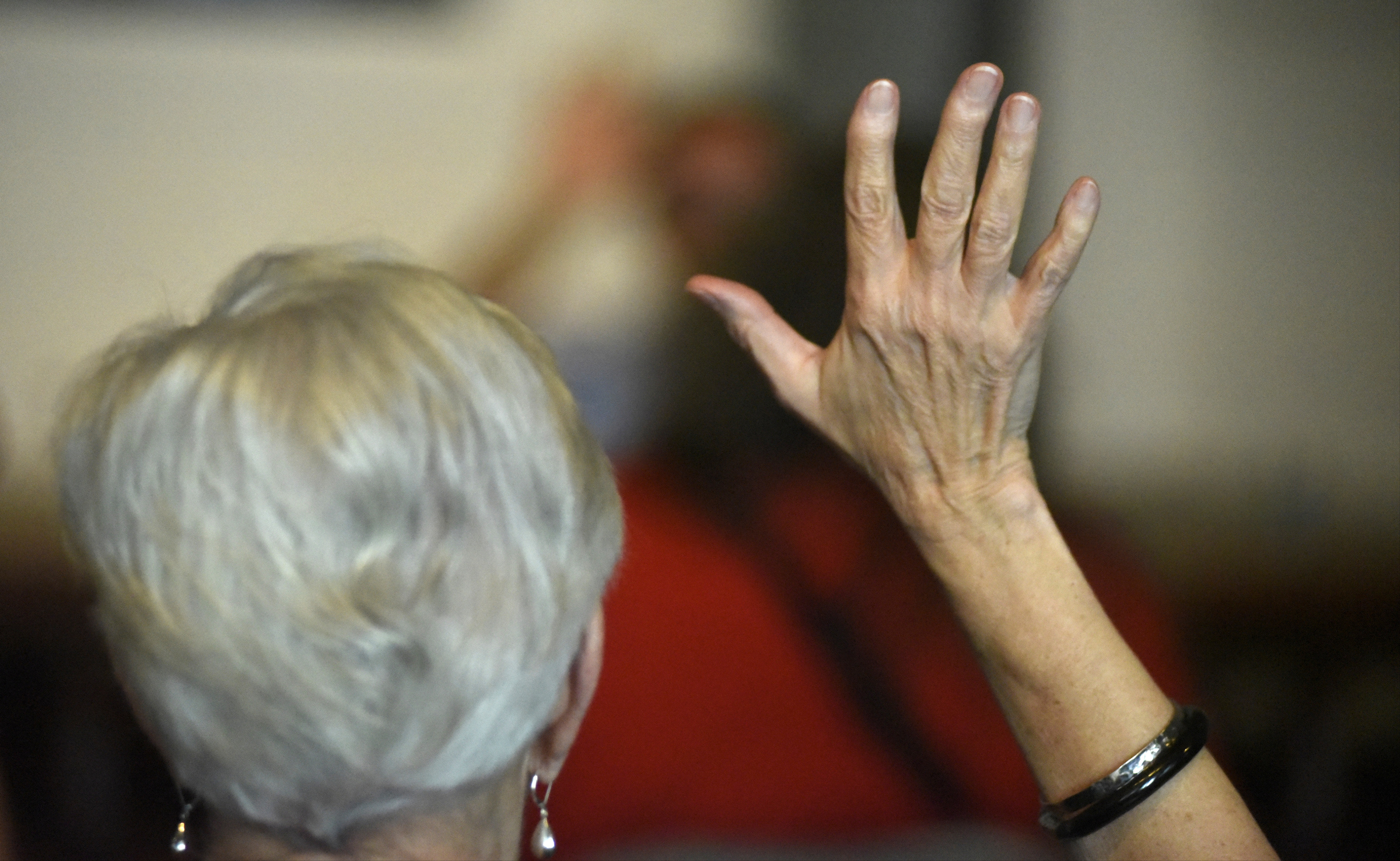 Dana Stubsten raises her hand during a worship service at the Mercy Junction Justice and Peace Center at St. Andrews in the Highland Park community on Sunday, Sept. 13, 2015, in Chattanooga, Tenn.