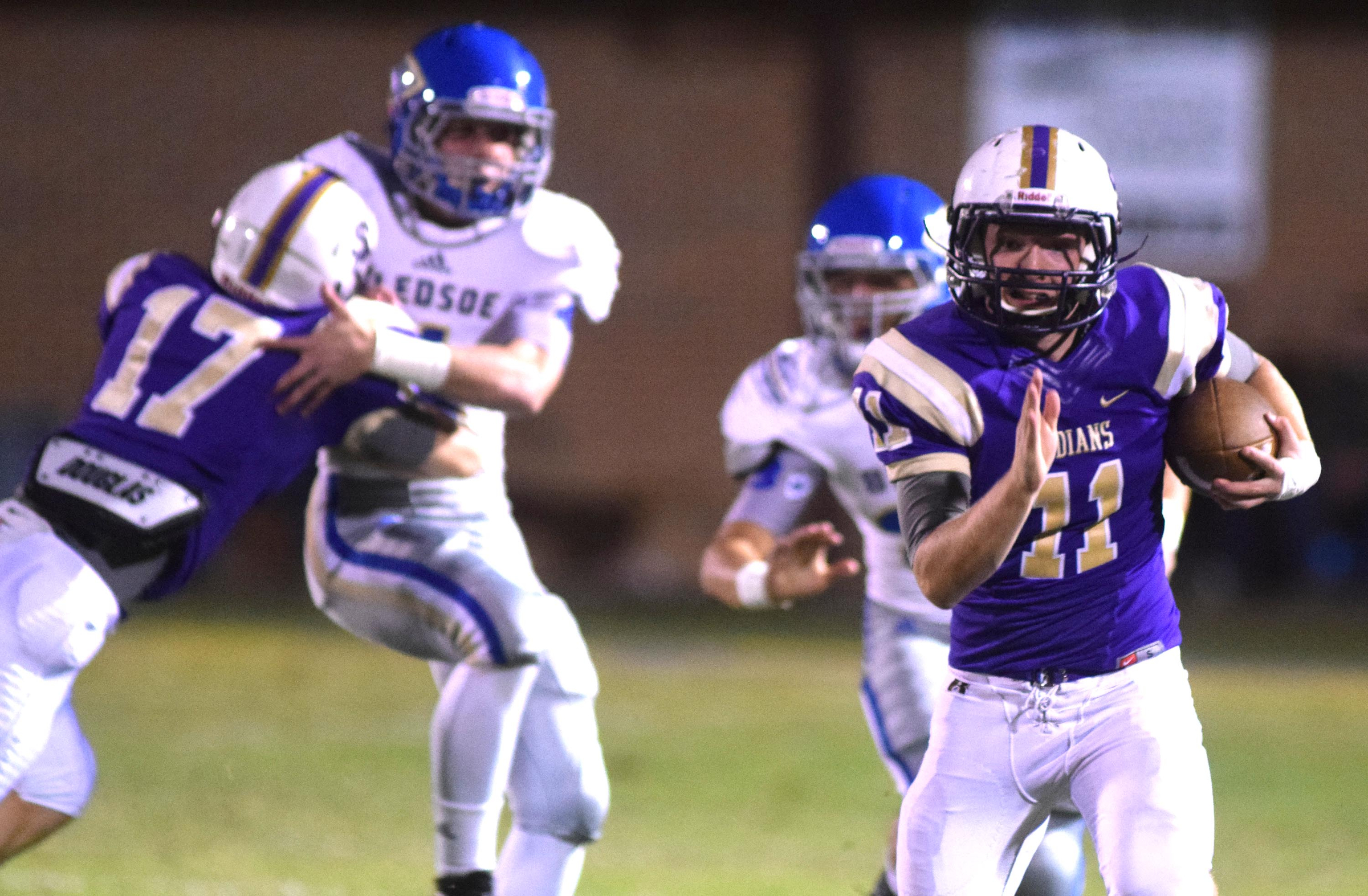 Sequatchie's Troy Sanders (11) returns a Bledsoe punt as teammate Colby Reed (17) blocks in the background. The Bledose County Warriors visited the Sequatchie County Indians in TSSAA football action Saturday September 25, 2015.