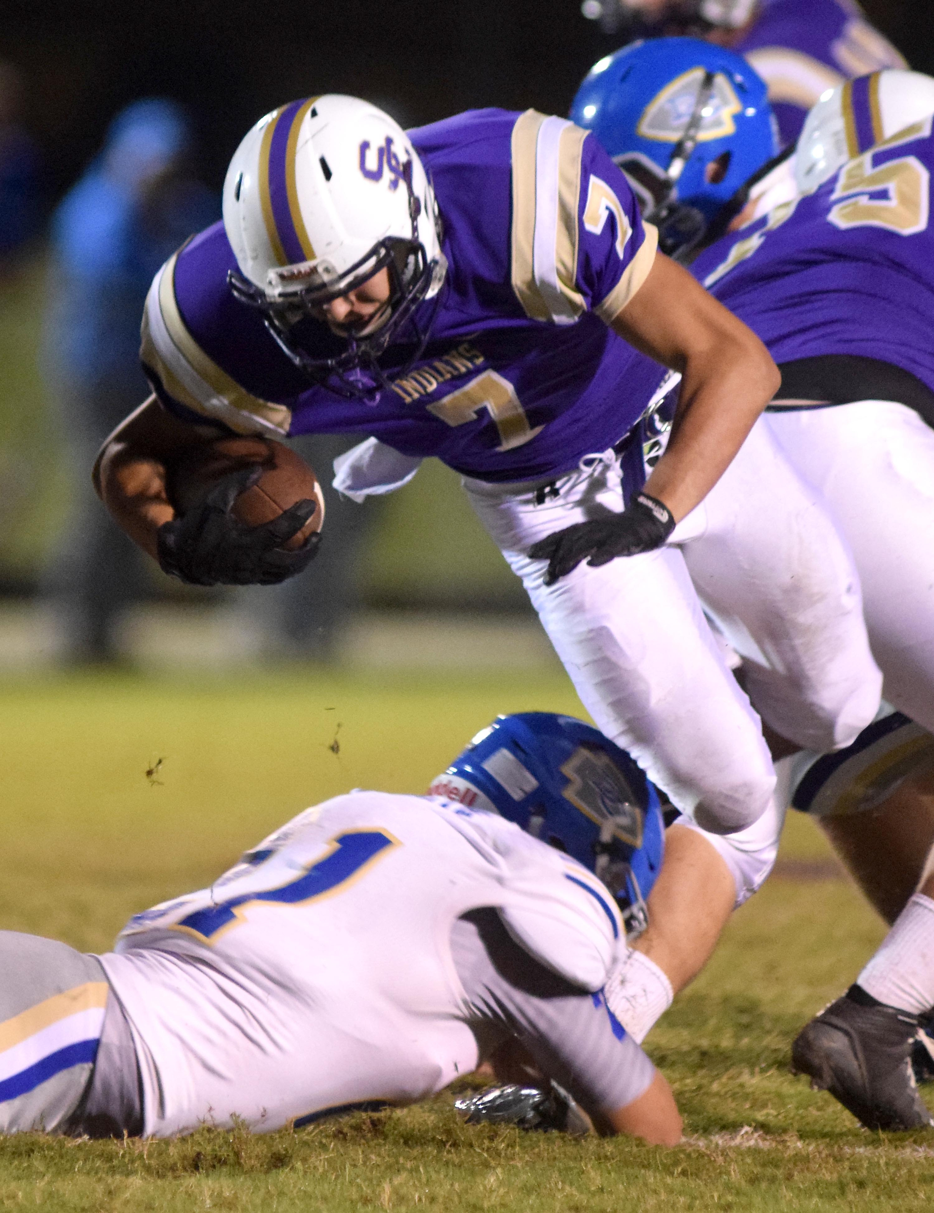 Staff Photo by Robin Rudd Sequatchie County's Brandon Rudd (7) is upended by Bledsoe County's Caleb Smith (21). The Bledsoe County Warriors visited the Sequatchie County Indians in TSSAA football action Saturday September 25, 2015.