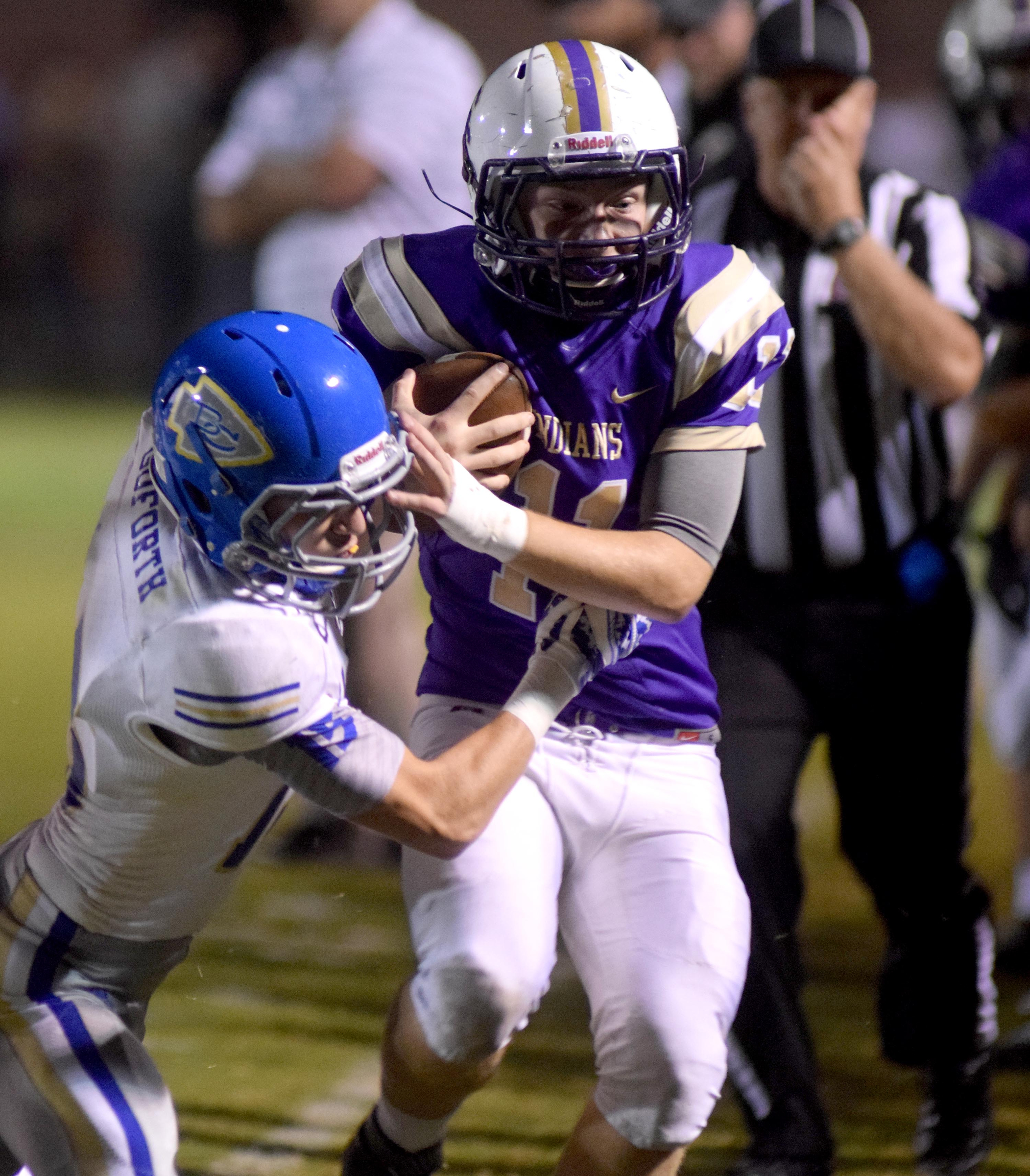 Sequatchie County's Troy Sanders (11) is knocked out-of-bounds by Bledsoe's Ryan Goforth (15). The Bledsoe County Warriors visited the Sequatchie County Indians in TSSAA football action Saturday September 25, 2015.