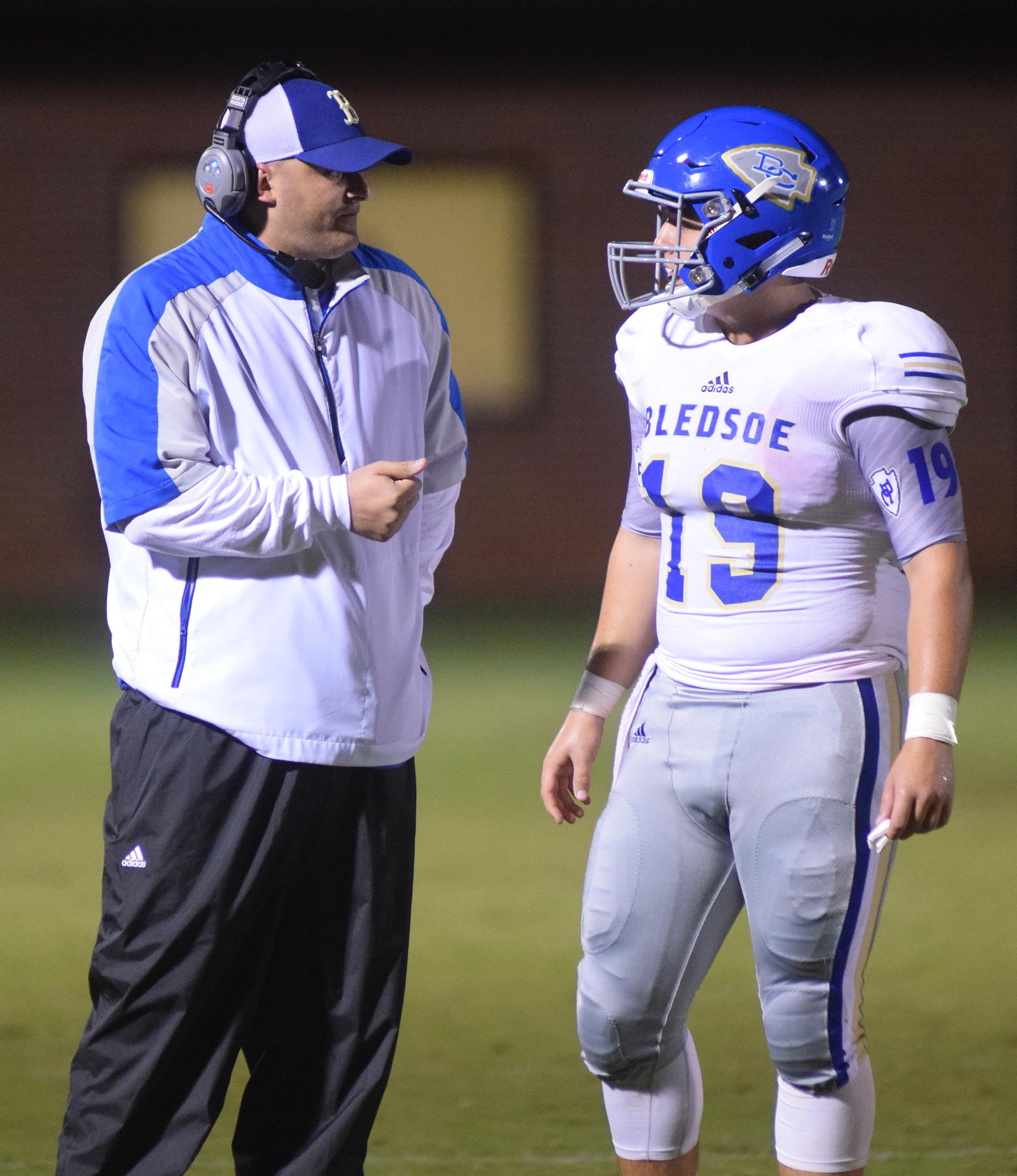 Staff Photo by Robin Rudd Bledsoe County head coach Josh Owensby talks to his quarterback Chaise Sorrow (19). The Bledsoe County Warriors visited the Sequatchie County Indians in TSSAA football action Saturday September 25, 2015.