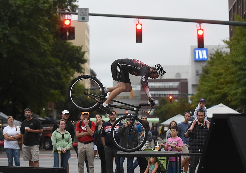 Dave Campbell balances his bike during Chattanooga's "Best Town Ever" celebration Friday, Sept. 25, 2015 at Miller Plaza.