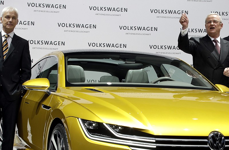 
              In this March 12, 2015 picture Volkswagen CEO Martin Winterkorn, right, and Porsche CEO and member of the board of Volkswagen, Matthias Mueller, left, pose for the media beside a car prior to the company's annual press conference in Berlin, Germany. Volkswagen’s supervisory board is meeting Friday, Sept. 25, 2015 to discuss who to name as CEO after Martin Winterkorn quit the job. Matthias Mueller, the 62-yead-old head of VW’s Porsche unit, emerged as one of the favorites.  (AP Photo/Michael Sohn)
            