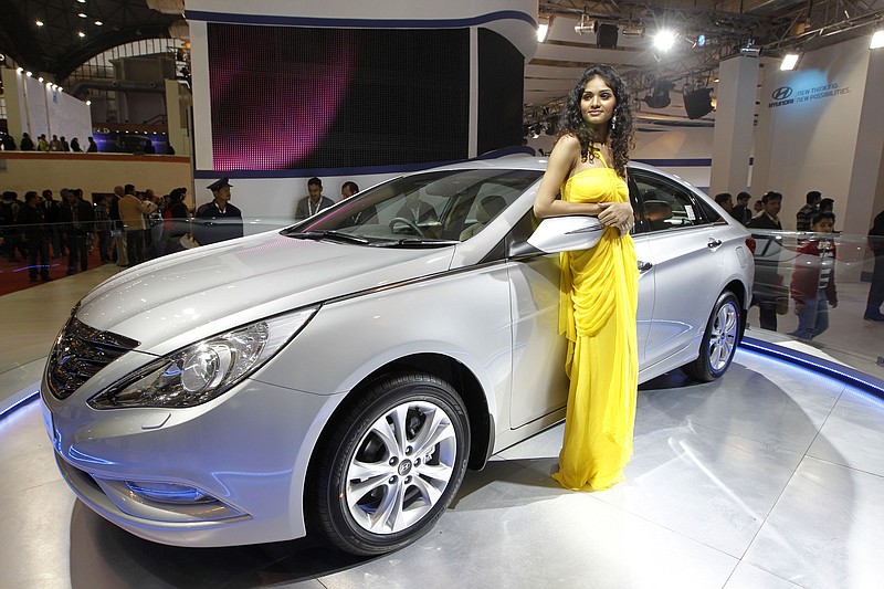 
              FILE - In this Jan. 6, 2012 file photo, a model poses near the new version of Hyundai Sonata displayed at the Hyundai stall during Auto Expo in New Delhi, India.   On Friday, Sept. 25, 2015, Hyundai is recalling nearly a half-million midsize cars in the U.S. to replace key engine parts because a manufacturing problem could cause them to fail. The recall covers 470,000 Sonata sedans from the 2011 and 2012 model years equipped with 2-liter or 2.4-liter gasoline engines. (AP Photo/Saurabh Das)
            