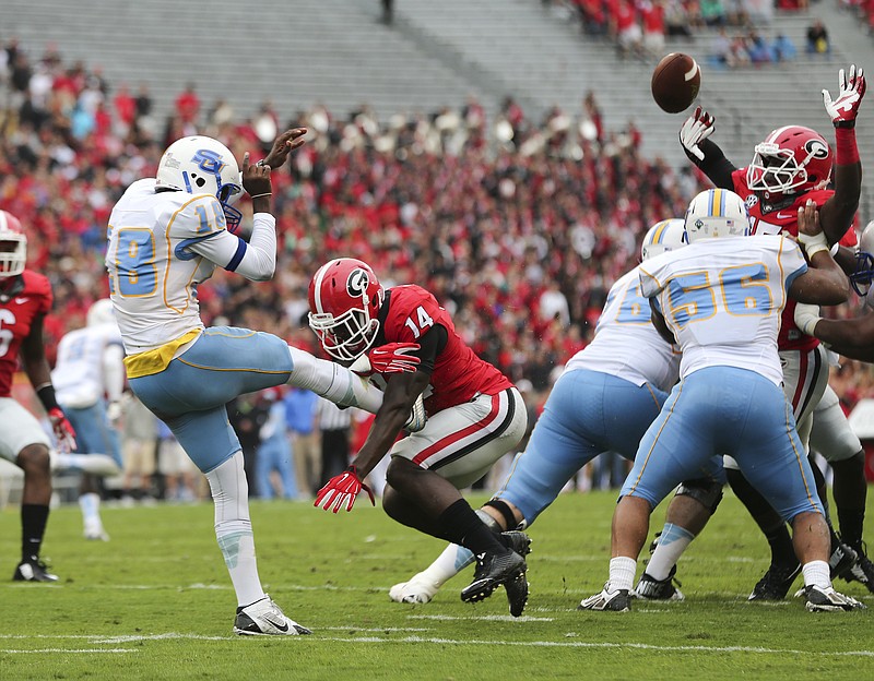 Southern punter Greg Pittman (18) has his punt blocked by Georgia's Malkom Parrish (14)in the first half of an NCAA college football game  Saturday, Sept. 26, 2015, in Athens , Ga. (AP Photo/John Bazemore) 