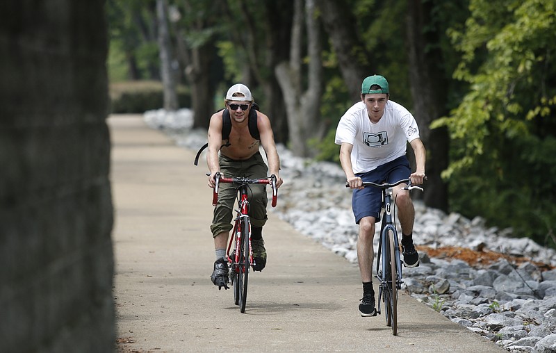 Cyclists ride along a section of the Tennessee Riverwalk in Chattanooga, Tenn., in this file photo.