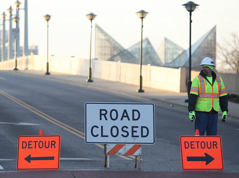 Shane Barger stands watch on the North Shore side of the Market Street Bridge, while the Tennessee Department of Transportation inspects the bridge, on Sunday.