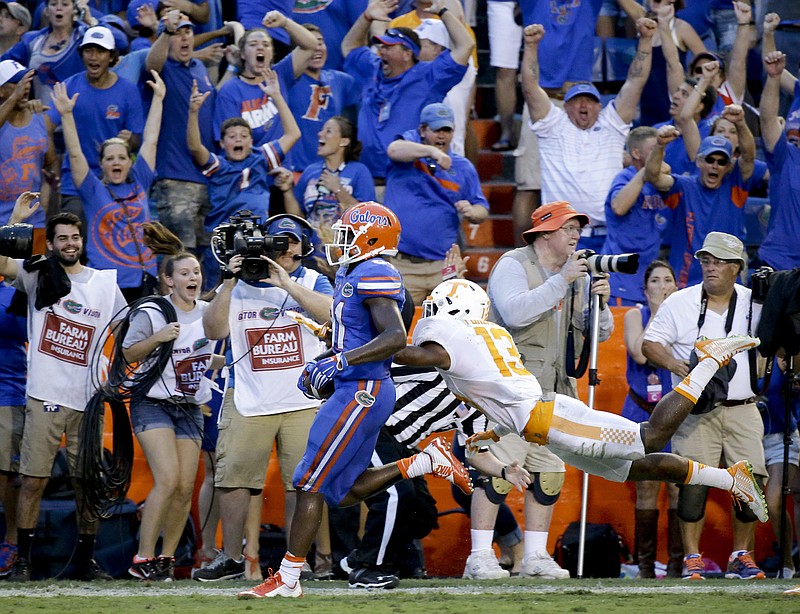 Florida wide receiver Antonio Callaway , left, crosses the goal line past Tennessee defensive back Malik Foreman, right, to score the game winning touchdown on a 63-yard pass play during the final minutes  of an NCAA college football game, Saturday, Sept. 26, 2015, in Gainesville, Fla. Florida won 28-27. (AP Photo/John Raoux)