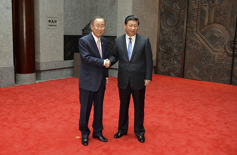 
              FILE - In this May 19, 2014 file photo, Chinese President Xi Jinping, right, shakes hands with United Nations Secretary General Ban Ki-moon, left, as they pose for photos on the eve of the fourth Conference on Interaction and Confidence Building Measures in Asia (CICA) summit at the Xijiao State Guesthouse in Shanghai, China. China’s President Xi is poised to address the U.N. General Assembly for the first time on Monday, Sept. 28, 2015. (Mark Ralston/Pool Photo via AP, File)
            