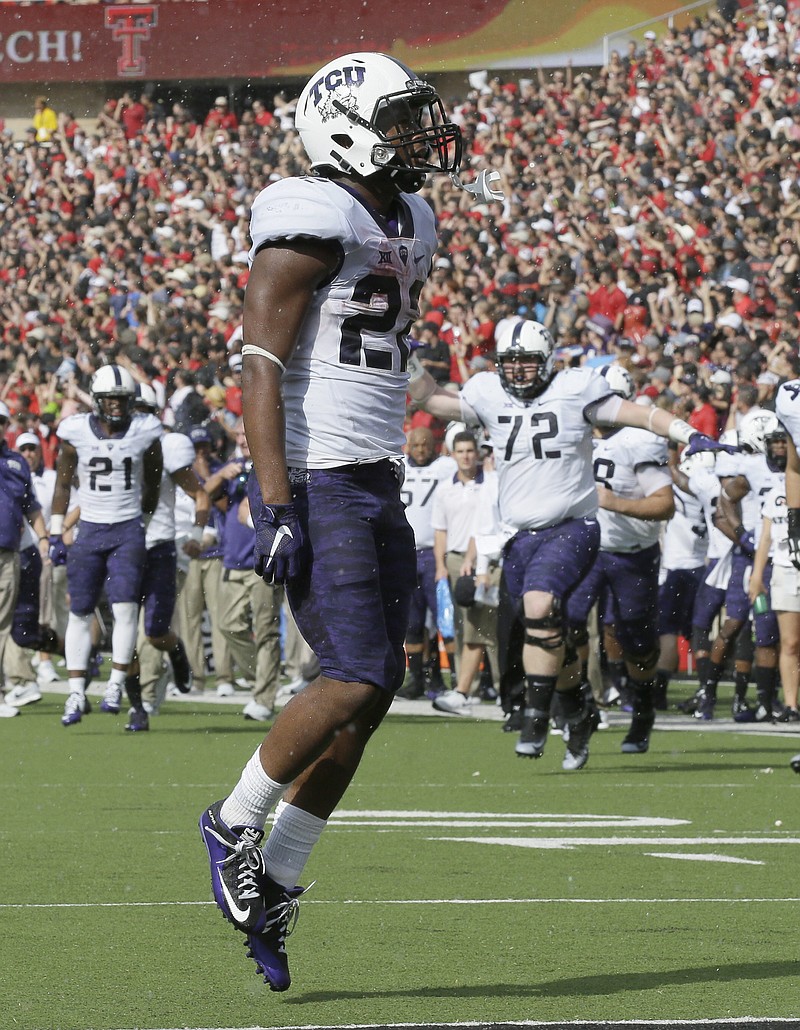 
              TCU running back Aaron Green celebrates scoring a touchdown during the first half of an NCAA college football game against Texas Tech, Saturday, Sept. 26, 2015, in Lubbock, Texas. (AP Photo/LM Otero)
            