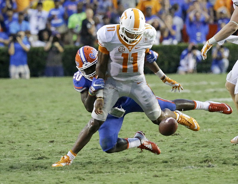 Tennessee quarterback Joshua Dobbs (11) loses the ball as he is tackled by Florida defensive back Marcus Maye (20) during the second half of an NCAA college football game, Saturday, Sept. 26, 2015, in Gainesville, Fla. Florida won 28-27. 