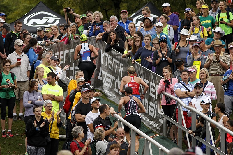 Athletes run up a ramp at Ross's Landing for the transition from swim to bike during the Ironman Triathlon on Sunday, Sept. 27, 2015, in Chattanooga, Tenn. 