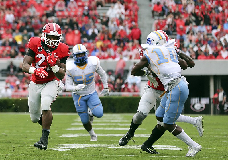 Georgia running back Nick Chubb runs away from Southern's Kentavious Preston (55) and Danny Johnson (10) for a touchdown in the first half Saturday in Athens , Ga.