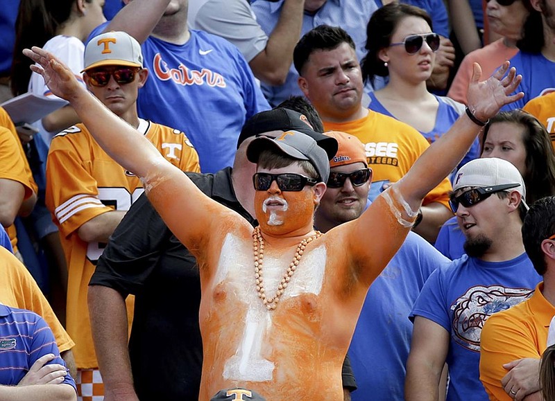 A Tennessee football fan cheers before Saturday's game at Florida. The latest fourth-quarter collapse by the Volunteers has some Big Orange supporters wondering about where the program is headed under coach Butch Jones.