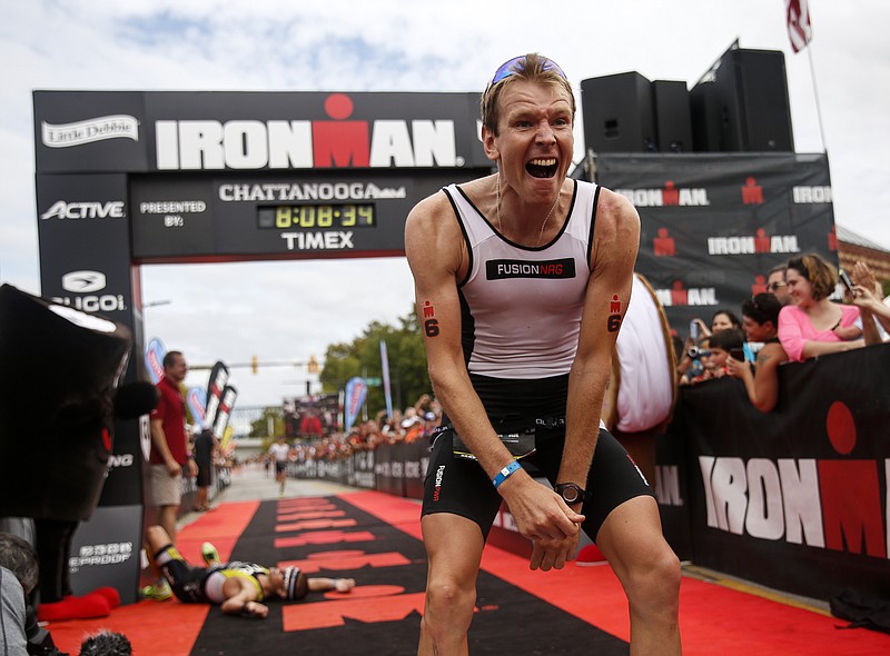 Kirill Kotsegarov reacts to winning the Ironman Triathlon in the final meters by just 2 seconds as second place finisher Matt Chrabot lays on the ground behind in the Ironman's closest finish in history on Sunday, Sept. 27, 2015, in Chattanooga, Tenn. This marks the second year the triathlon has been held in Chattanooga.