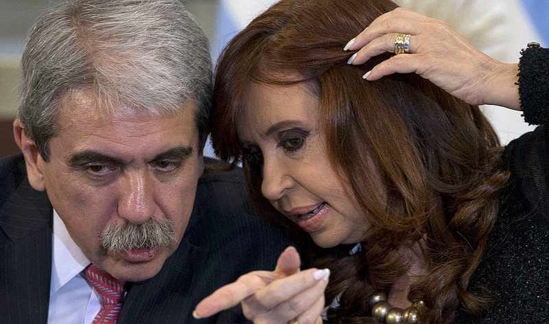 
              In this Thursday, Aug. 20, 2015 photo, Argentina's Cabinet chief Anibal Fernandez, left, and President Cristina Fernandez talk during a ceremony at the government house in Buenos Aires, Argentina. For voters in Argentina, which has suffered periodic financial crises and has the dubious distinction of the largest default in world history, the top issues are crime and the economy, not political corruption. (AP Photo/Natacha Pisarenko)
            