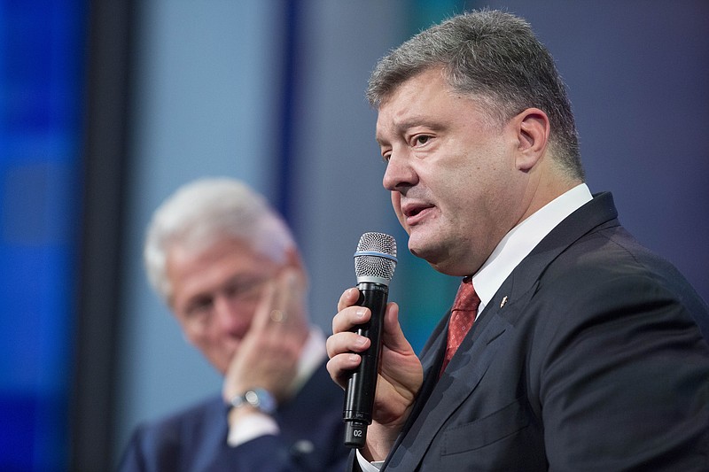 
              Former President Bill Clinton, left, listens as Petro Poroshenko, the President of Ukraine,  speaks at the Clinton Global Initiative, Sunday, Sept. 27, 2015  in New York. (AP Photo/Mark Lennihan)
            