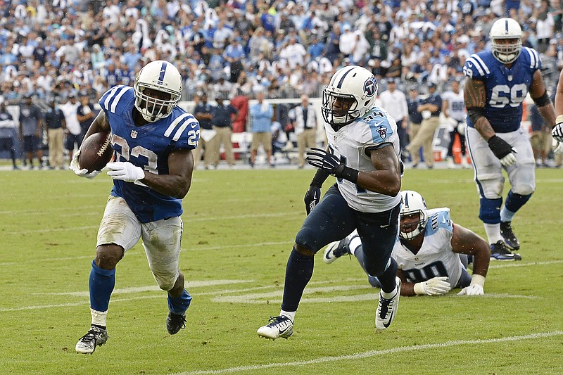 Indianapolis Colts running back Frank Gore (23) gets past Tennessee Titans linebacker Avery Williamson (54) as Gore scores a touchdown on a 6-yard run in their game Sunday, Sept. 27, 2015, in Nashville.