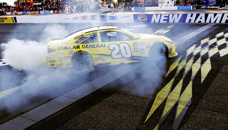 Matt Kenseth celebrates at the finish line after winning the NASCAR Sprint Cup series auto race at New Hampshire Motor Speedway, Sunday, Sept. 27, 2015, in Loudon, N.H.