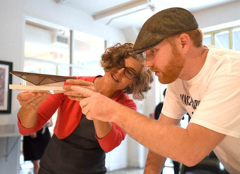 Collette Creppell, left, shows a model to Michael Gilliland Monday, Sept. 28, 2015 at Causeway during an open house to discuss future plans for the Miller Park District.