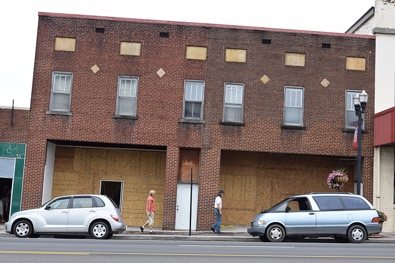 Hillborn Distillery is setting up shop in Etowah, Tenn., in the 600 block of Tennessee Avenue. At right in the white shirt, Dean Donally, one of the partners in the distillery, says the store fronts will be restored to their original look.