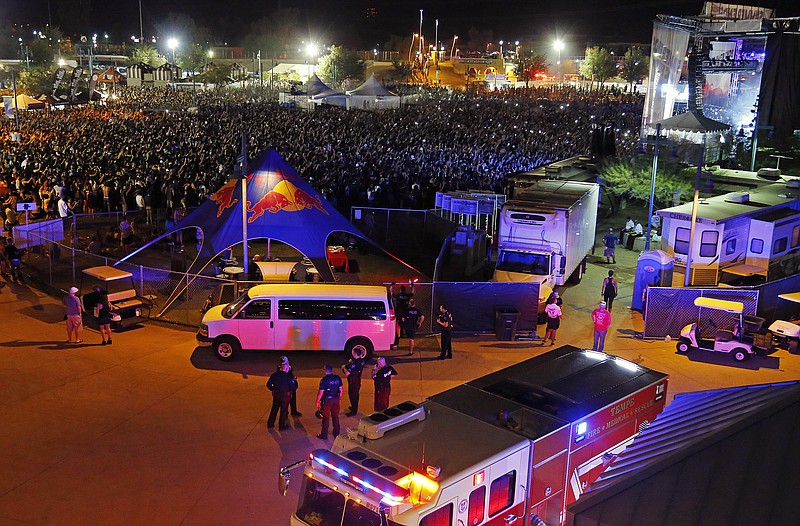 
              Fire units and ambulances line up to transport injured concert goers at Tempe Beach Park Saturday, Sept. 26, 2015 in Tempe, Ariz. An Arizona music festival is set to resume for a Kanye West performance after as many as 12 people were injured when a crowd rushed a stage, officials said Sunday. (David Kadlubowski/The Arizona Republic via AP)  MARICOPA COUNTY OUT; MAGS OUT; NO SALES; MANDATORY CREDIT
            