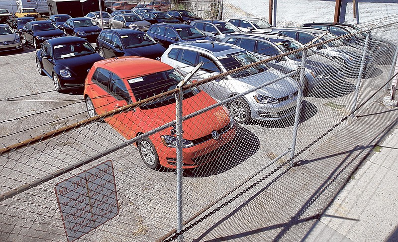 Diesel Volkswagens are seen behind a security fence on a storage lot near a VW dealership in Salt Lake City.