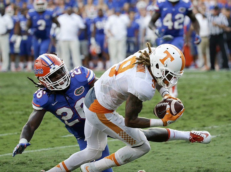 Tennessee wide receiver Von Pearson (9) catches a touchdown pass in front of Florida's Marcell Harris during the second half of Saturday's game in Gainesville, Fla. But the play was negated by a penalty, leaving the Vols with only two receptions by wideouts in their 28-27 loss.