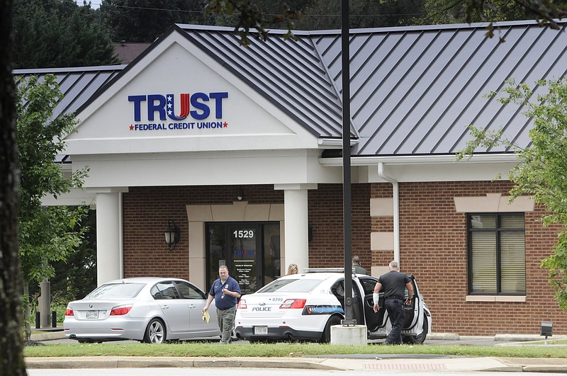 Chattanooga police work a bank robbery at Trust Federal Credit Union on Gunbarrel Road early Tuesday. 