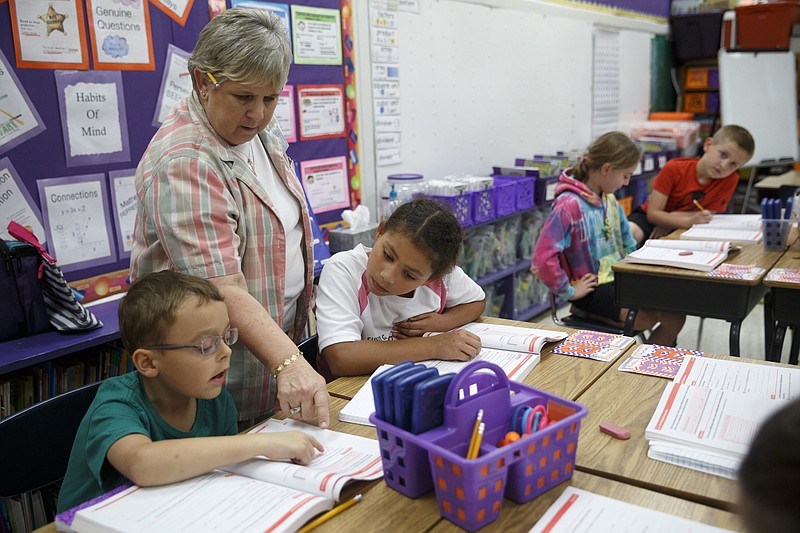 3rd grade teacher Nelle Ward directs students Zachary Schaap, left, and Amya Hensley in an assignment at Falling Water Elementary School on Tuesday, Sept. 29, 2015, in Hixson, Tenn. The school was named a National Blue Ribbon School on Tuesday by the U.S. Department of Education.