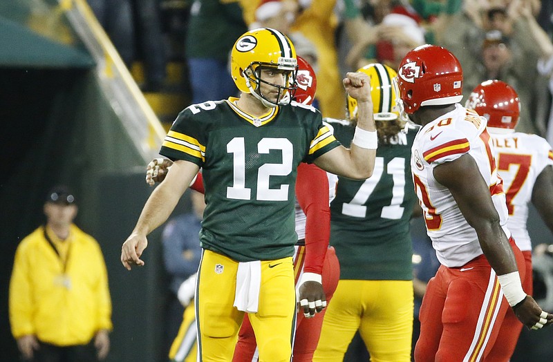 Green Bay Packers' Aaron Rodgers celibates a touchdown reception to Ty Montgomery during the first half of an NFL football game against the Kansas City Chiefs on Monday, Sept. 28, 2015, in Green Bay, Wis.