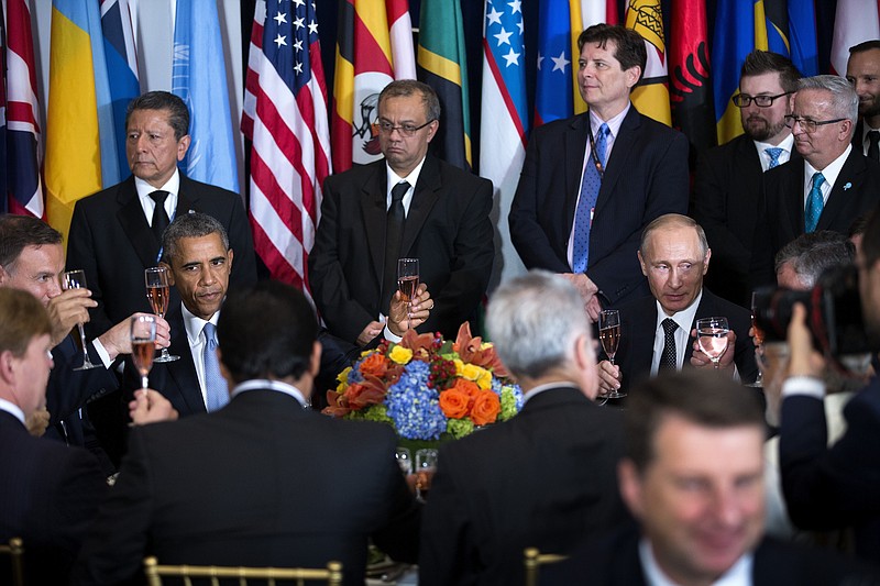 Russian President Vladimir Putin and President Barack Obama raise glasses during a luncheon hosted by United Nations Secretary-General Ban Ki-moon at the United Nations on Monday.