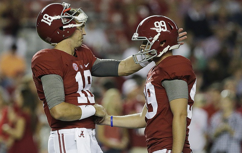 Alabama backup quarterback and holder Cooper Bateman, left, talks with kicker Adam Griffith before a recent game at Bryant-Denny Stadium.